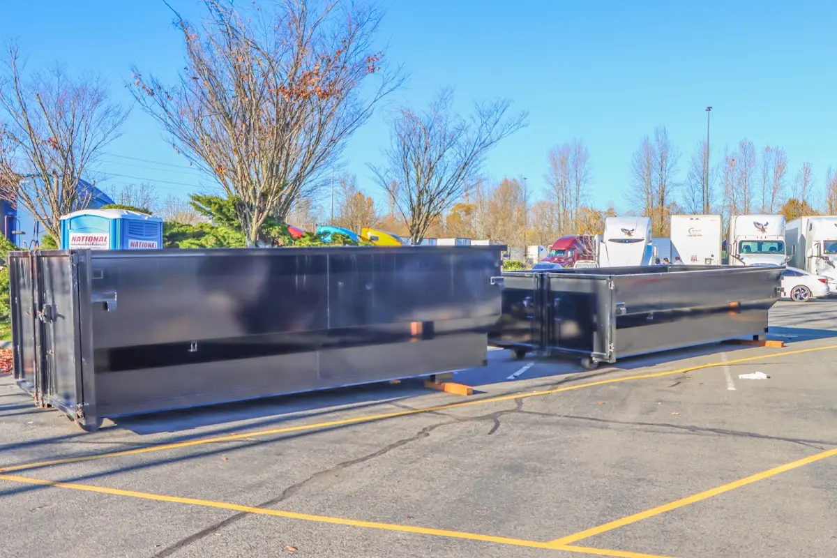 Professional dumpster rental service with roll-off container on residential driveway in Pepper Pike